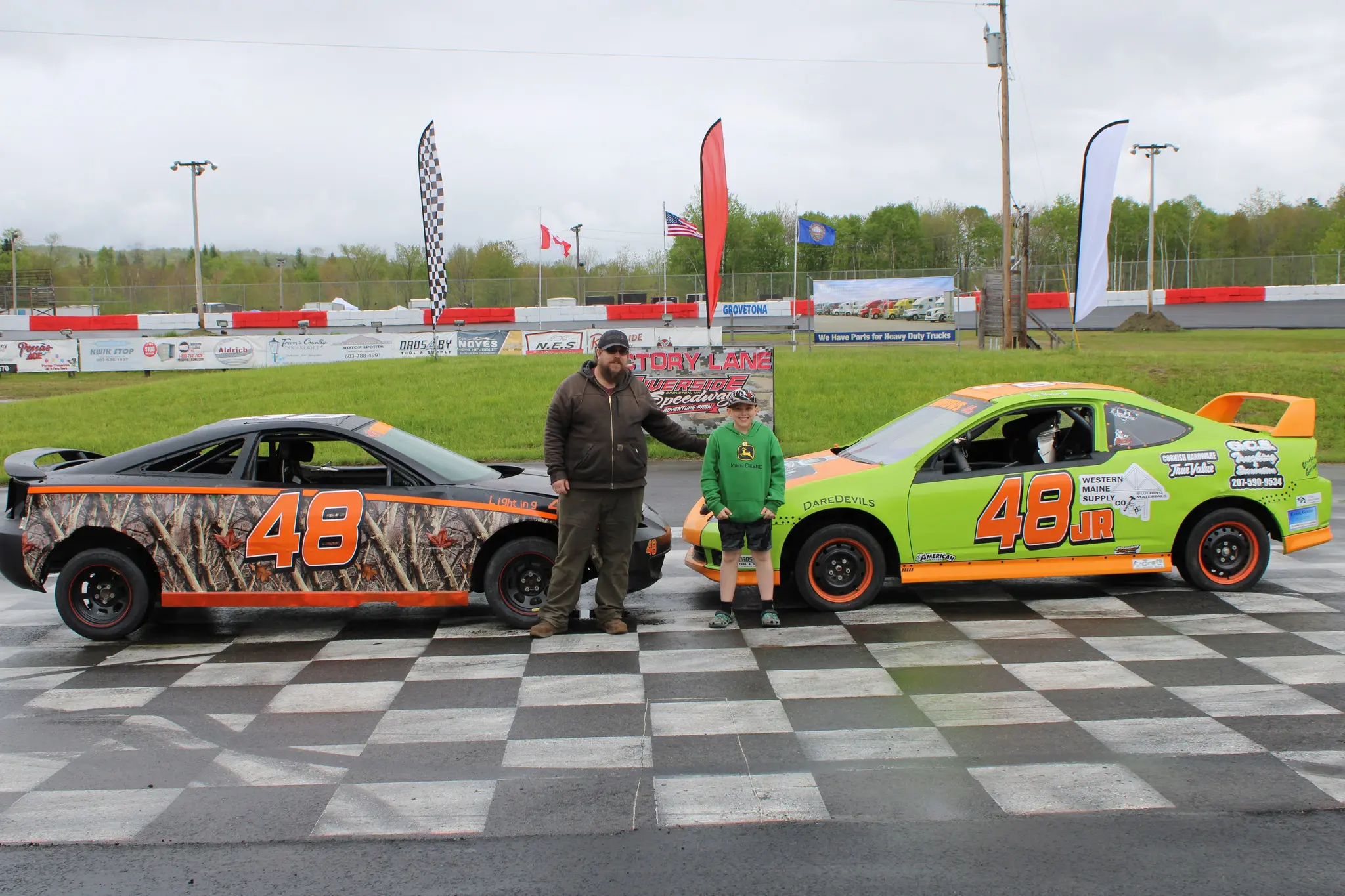 Race cars on track with two people