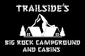 Trailside's campground logo with cabins