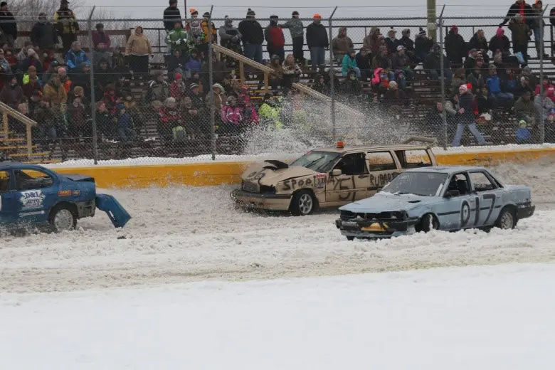 Spectators watching snowy car race